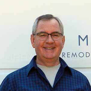 Square image of Patrick Richardson smiling next to the company van